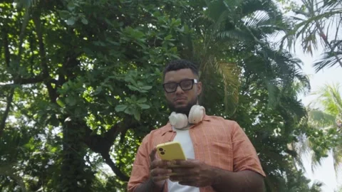 Young man using smartphone outdoors in park Stock-Footage 341441890