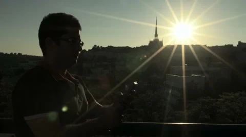 Young man using a smartphone over a sunset Stock Footage 41966883