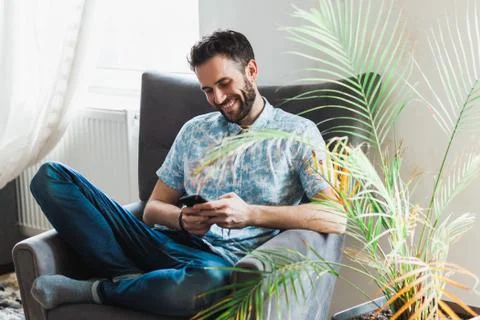 Young man using a smartphone Stock Photos