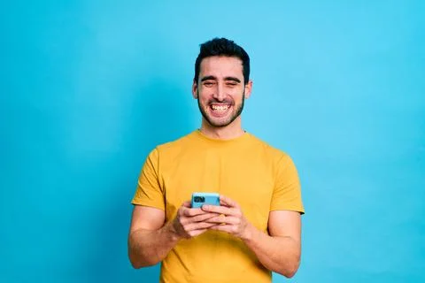 Young man using a smartphone Stock Photos