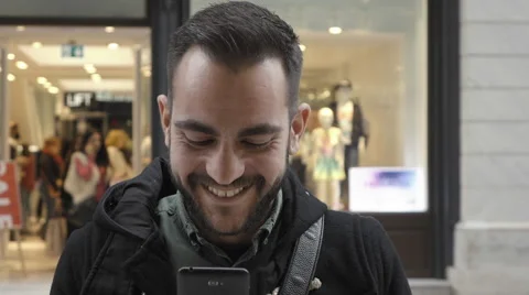 Young man using smartphone in public commercial street slomo Stock Footage 60455443