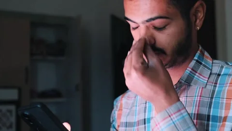 Young Man Using Smartphone Removing Glasses Due to Eye Strain 스톡 동영상 329369651