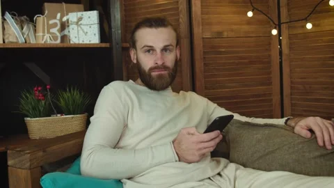Young Man is Using Smartphone in sending message on Social Media At Home Stock Footage 147034181
