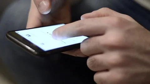 Young man using a smartphone to shop online from home in Milan, Italy Stock Footage 76103995