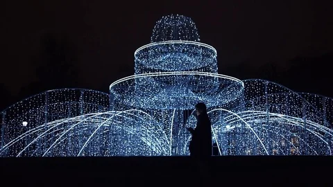 Young man using smartphone standing alone outdoors at night Video stock 83630959