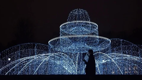 Young man using smartphone standing alone outdoors at night Stock Footage 83630983