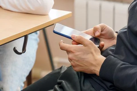 Young Man using a smartphone for texting and communication Stock-Fotos