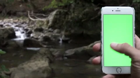 Young man using smartphone watching green screen enjoying entertainment on Stock Footage 131679655