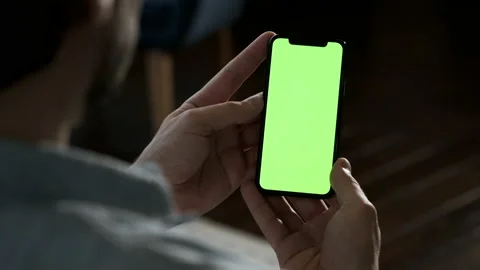 Young man using smartphone watching green screen enjoying entertainment Stock Footage 144682736