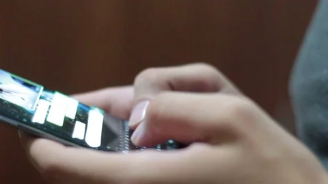 Young man using smartphone while doing homework. Stock Footage 119820330