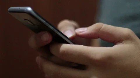 Young man using smartphone while doing homework. Stock Footage 119820410