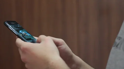 Young man using smartphone while doing homework. Stock Footage 127529280