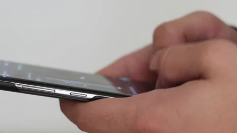 Young man using smartphone while doing homework. Stock Footage 144750100