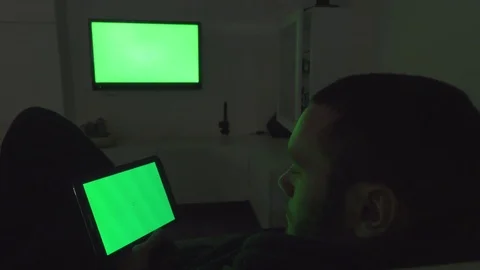 Young Man Using Tablet and Tv. Green Screen Stock Footage 72163456