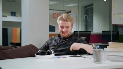 A Young Man Using a Tablet and Listening to Music Stock Footage 86297936