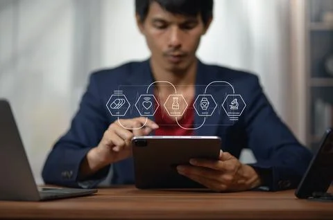 Young Man Using Tablet for Business Technology with Digital Creative Icons Stock Photos
