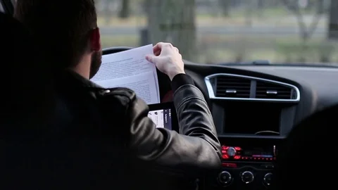 Young man using a tablet in the car. student performing tasks in the car Stock Footage 81928698