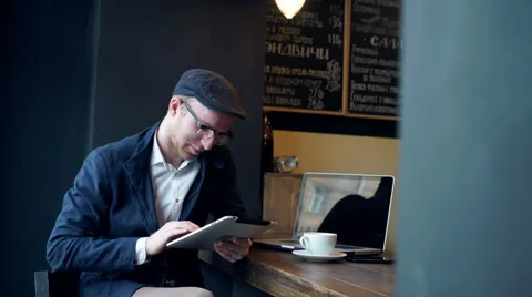 Young man using tablet computer in cafe Stock Footage 61450473