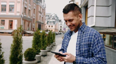 Young man using tablet computer on street Stock Footage 62627601