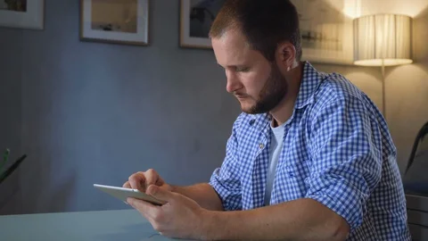 Young Man Using Tablet Computer Smiling Guy Chatting Online Over Big Window Stock Footage 128551515
