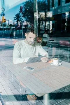 Young man using tablet computer in cafe Stock Photos