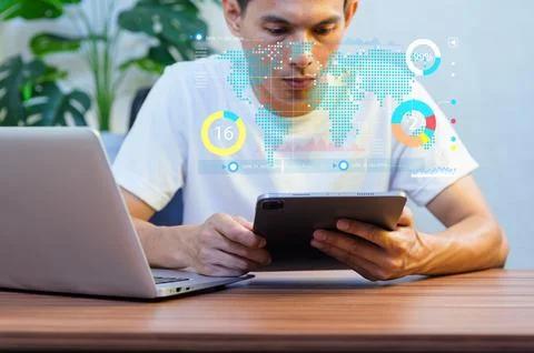 Young Man Using Tablet for Digital Analytics and Data Visualization Fotos de archivo