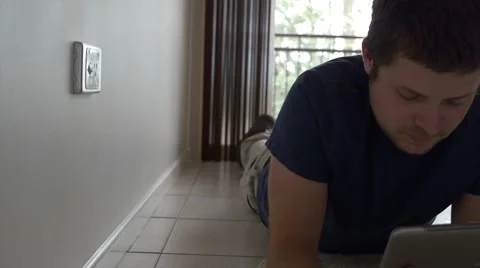 Young Man Using Tablet on Floor Stock Footage 40274780