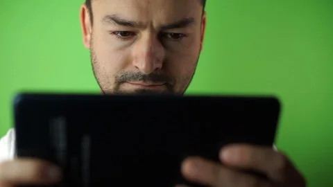 Young man using tablet green screen background Video stock 87175665