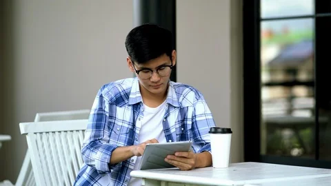 Young man using tablet in hand looking camera and smile Stock Footage 106550034