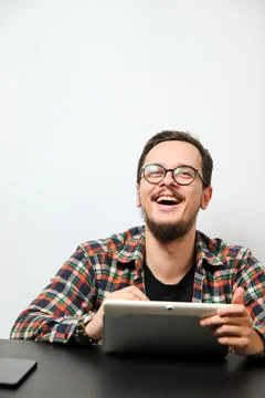 Young man using a tablet with a happy smile. Modern young man with tablet and 스톡 사진