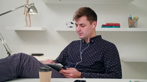 A Young Man Using a Tablet Indoors. Stock Footage 83837535