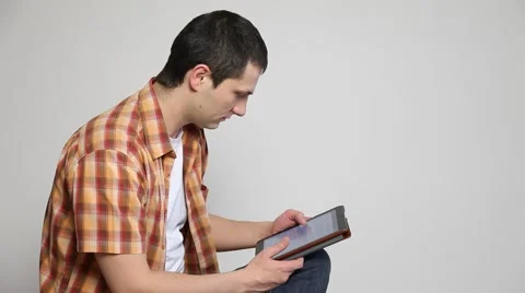 Young man using a tablet / map-case Stock Footage 60064289