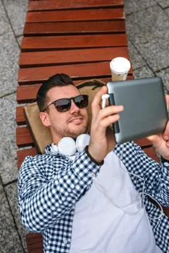 Young man using tablet outdoors Stock Photos
