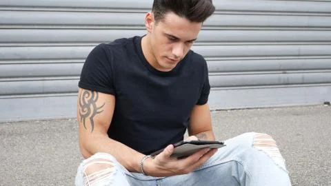 Young man using tablet PC outdoor in city Stock Photos