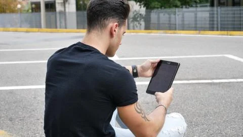 Young man using tablet PC outdoor in city Stock Photos