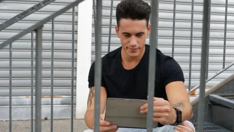 Young man using tablet PC outdoor in city Stock Photos