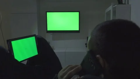 Young Man Using Tablet, Tv and Smartphone. Green Screen Stock Footage 72162262