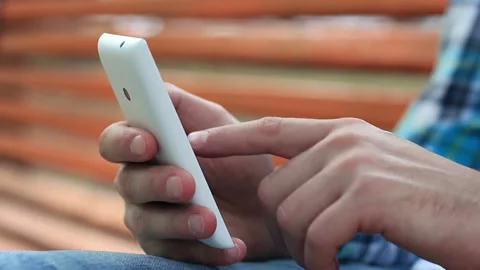 Young Man Using Touchscreen Phone Stock Footage 120123431