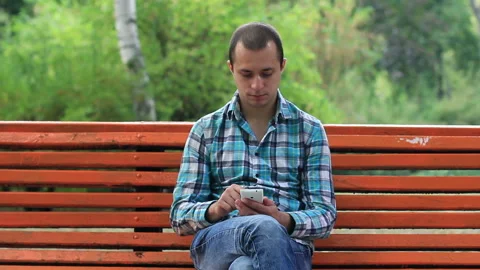 Young Man Using Touchscreen Phone Stock Footage 120124383