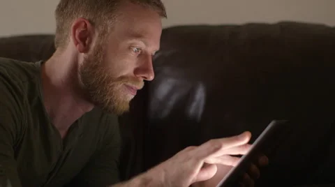 Young man using touchscreen tablet technology and reading. Stock Footage 45872247