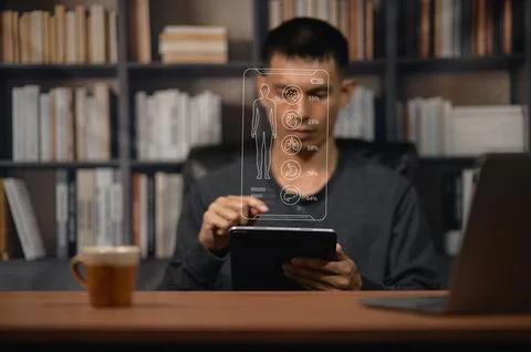 Young Man Using Transparent Smartphone Interface with Digital Human Body Di.. Foto stock