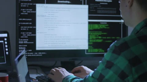Young man using two computers for programming at home Stock Footage 142980103