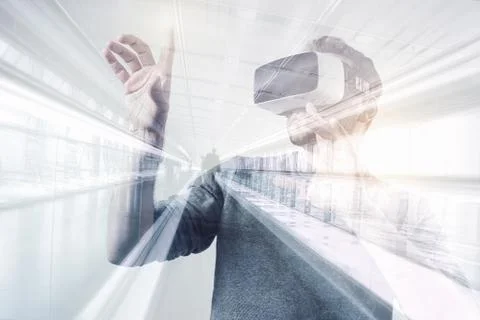 Young man using a virtual reality headset - futuristic concept image Stock Photos