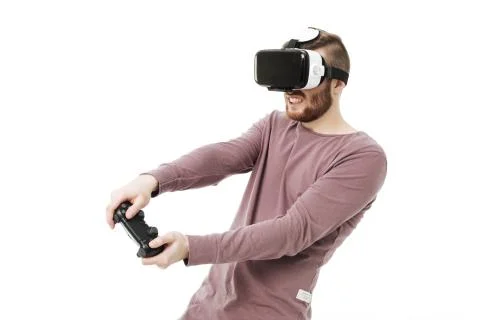 Young man using virtual reality glasses and playing video game on white Stock Photos