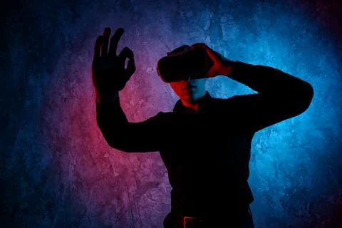 Young man using Virtual Reality glasses. Show ok Foto stock