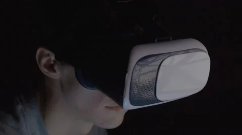 Young man using VR glasses in dark room close up Stock Footage 68930464