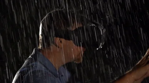 Young man using VR glasses at night in the rain, close up. Internet and Technolo Stock Footage 80179560