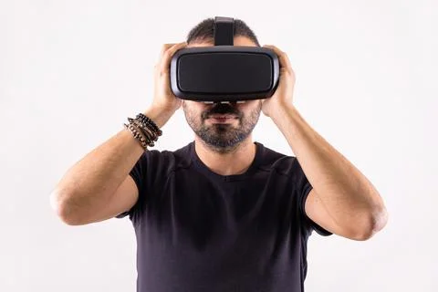 Young man using VR glasses headset holding with hands, portrait. Virtual reality Stock Photos