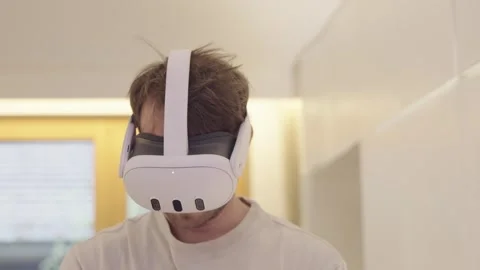 Young man using a vr headset for immersive augmented reality gaming and digital Stock-Footage 335152152