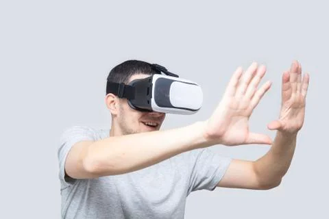 Young man using vr headset, experiencing virtual reality Stock Photos